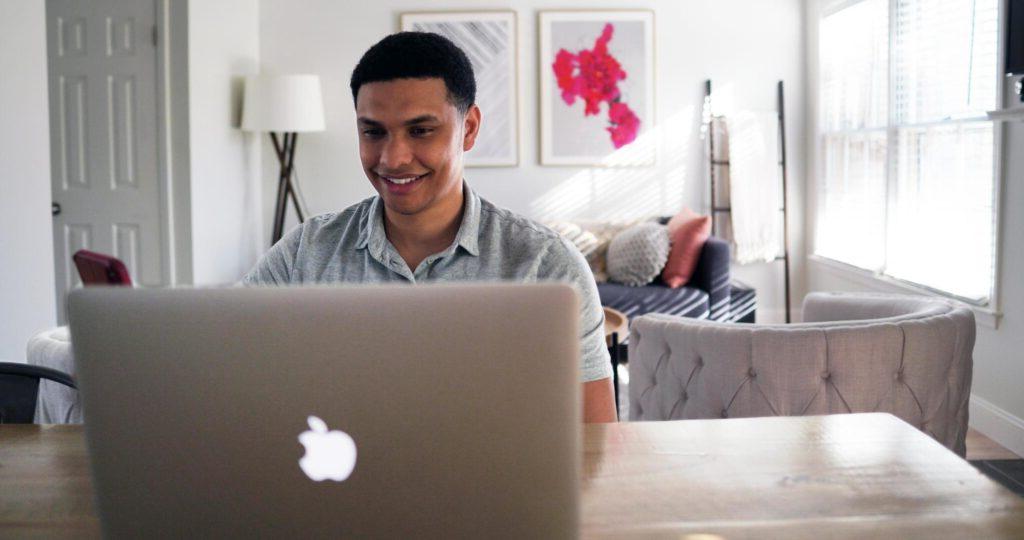 man working from a laptop in a home office